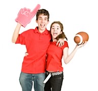 Two enthusiastic teen football fans jumping for joy. Full body isolated on white.